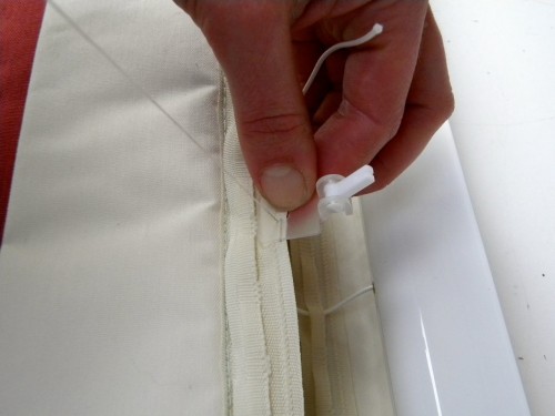 The safety catches are hand-sewn onto the back of the blind